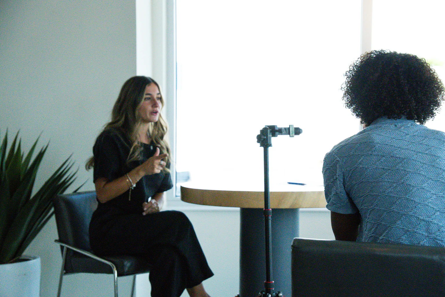 Jada Andreozzi and Nelson Rivera planning shots next to a tripod before a content shoot